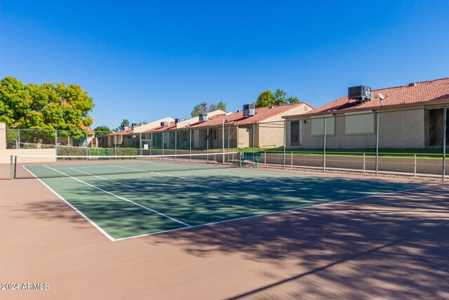 view of tennis court featuring fence