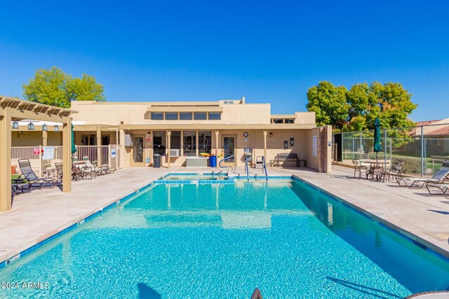 pool featuring a patio area and fence