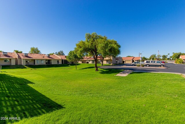 view of home's community featuring a residential view and a lawn