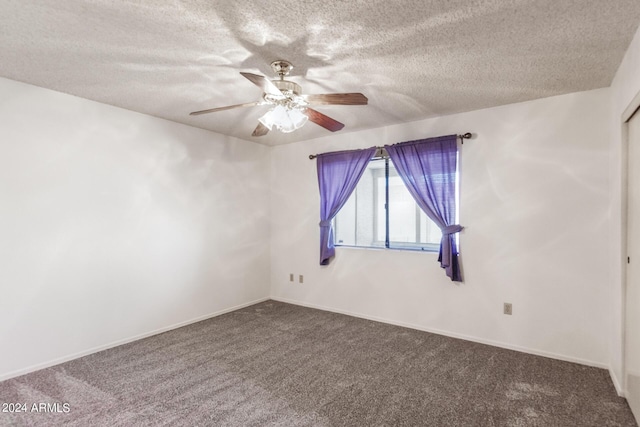 empty room featuring carpet flooring, ceiling fan, a textured ceiling, and baseboards