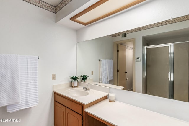 bathroom with a stall shower, visible vents, and vanity