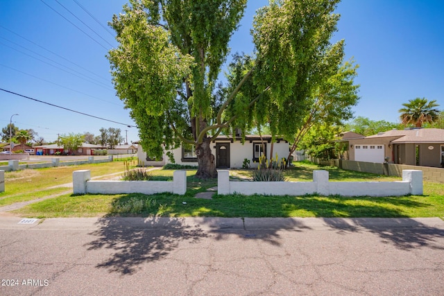 view of front of property with a front lawn and a garage