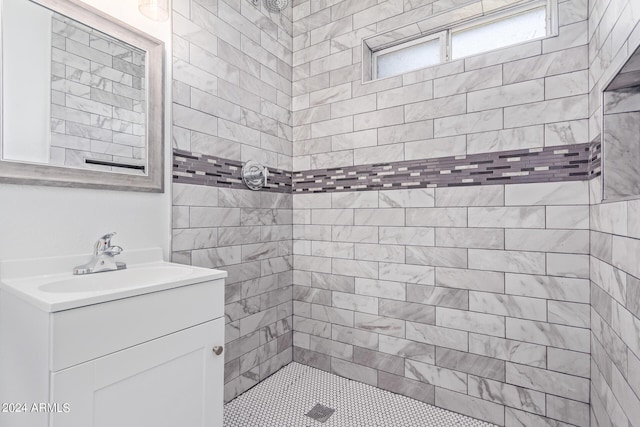 bathroom featuring vanity and tiled shower