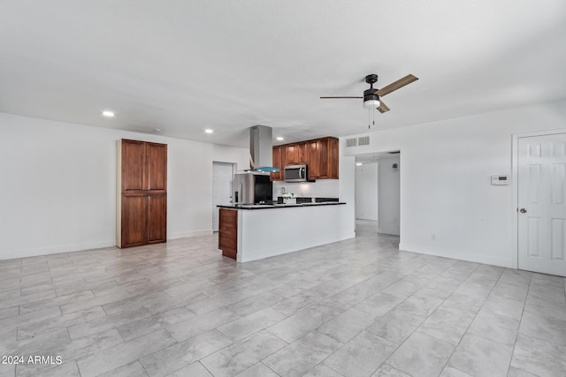 kitchen featuring island exhaust hood, ceiling fan, and appliances with stainless steel finishes