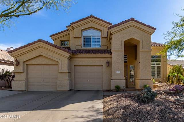 mediterranean / spanish-style home with a garage