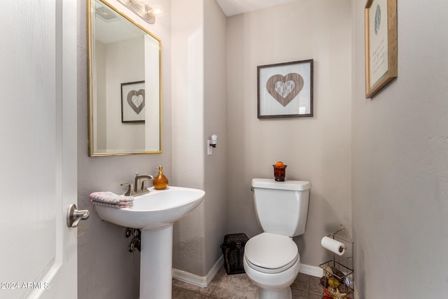 bathroom featuring tile patterned flooring and toilet