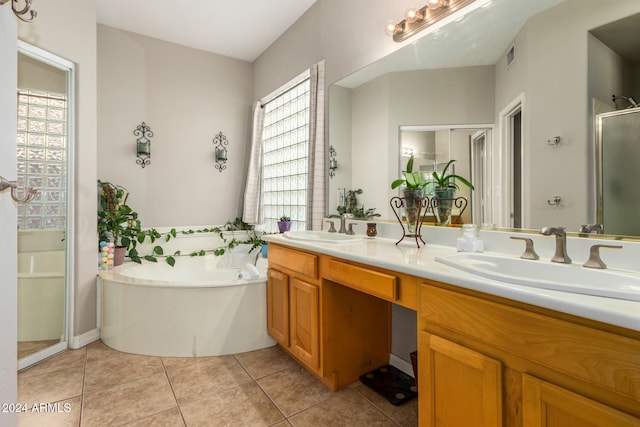 bathroom with tile patterned flooring, vanity, and plus walk in shower