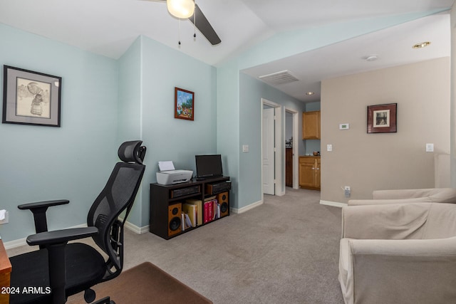 carpeted office space featuring ceiling fan and vaulted ceiling