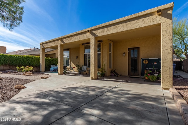 back of property featuring a patio area