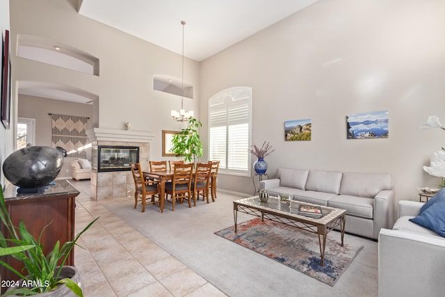 carpeted living room with a fireplace and high vaulted ceiling