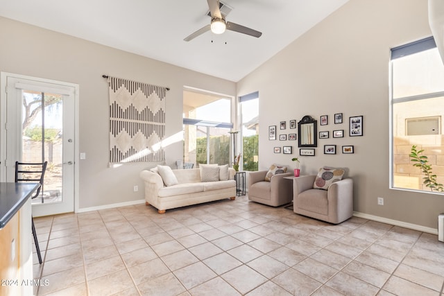 tiled living room featuring ceiling fan and high vaulted ceiling