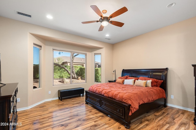 bedroom with light hardwood / wood-style floors and ceiling fan