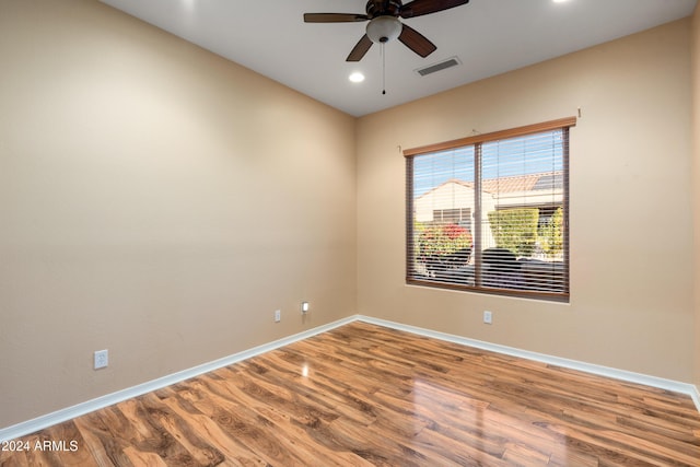 empty room with recessed lighting, visible vents, ceiling fan, wood finished floors, and baseboards