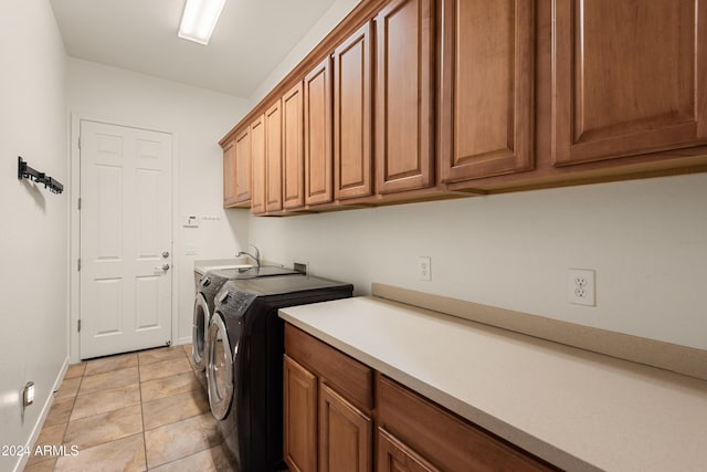 clothes washing area featuring cabinets, independent washer and dryer, and light tile patterned flooring