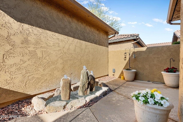 view of home's exterior featuring a tile roof and stucco siding