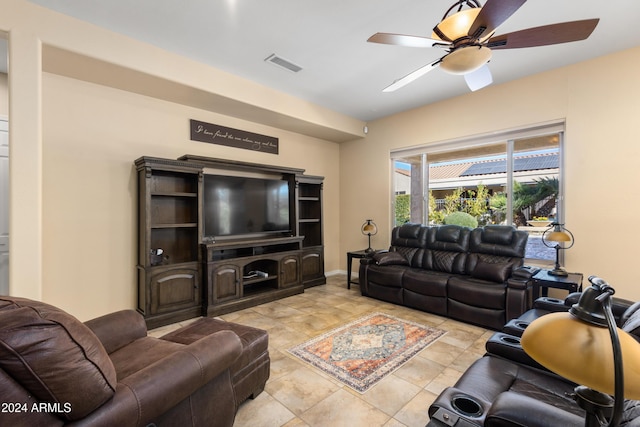 living room featuring baseboards, visible vents, and a ceiling fan