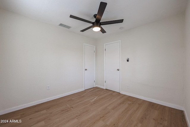 unfurnished room with ceiling fan and light wood-type flooring