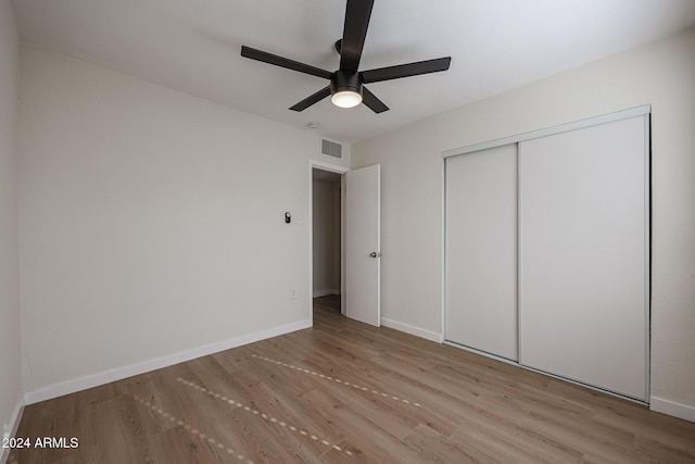 unfurnished bedroom with a closet, ceiling fan, and light hardwood / wood-style flooring