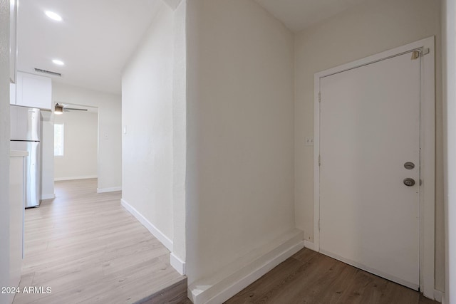 corridor with light hardwood / wood-style floors