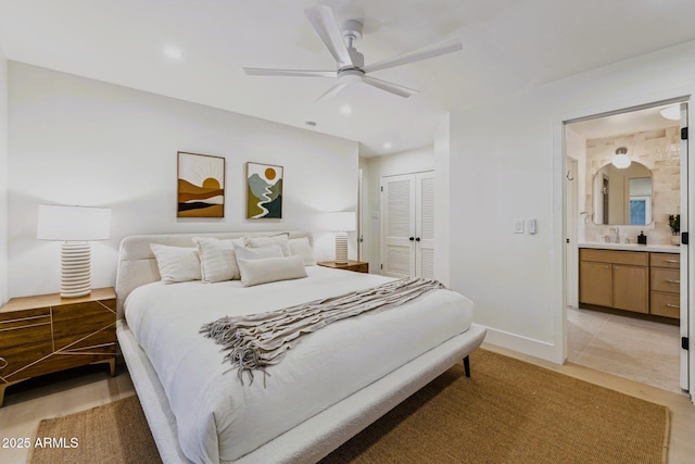 bedroom with ensuite bath, recessed lighting, a closet, and a sink