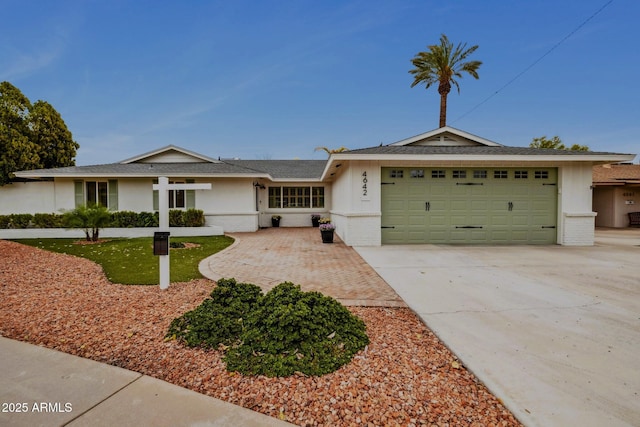 ranch-style house featuring brick siding, concrete driveway, a garage, and roof with shingles