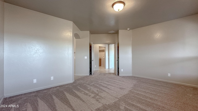 unfurnished room featuring light colored carpet