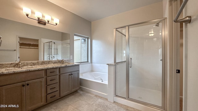 bathroom with tile patterned flooring, vanity, and independent shower and bath