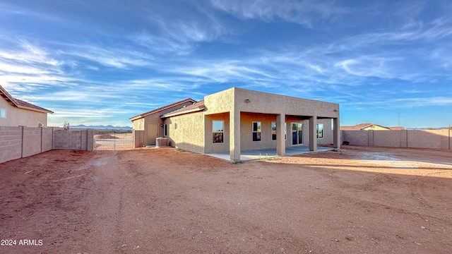 back of property with a patio area and cooling unit