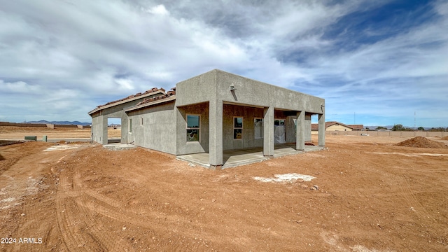 back of property featuring a patio area