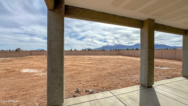 view of yard with a mountain view and a patio