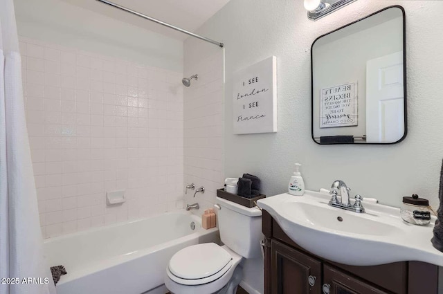 bathroom featuring toilet, a textured wall, shower / bath combo, and vanity