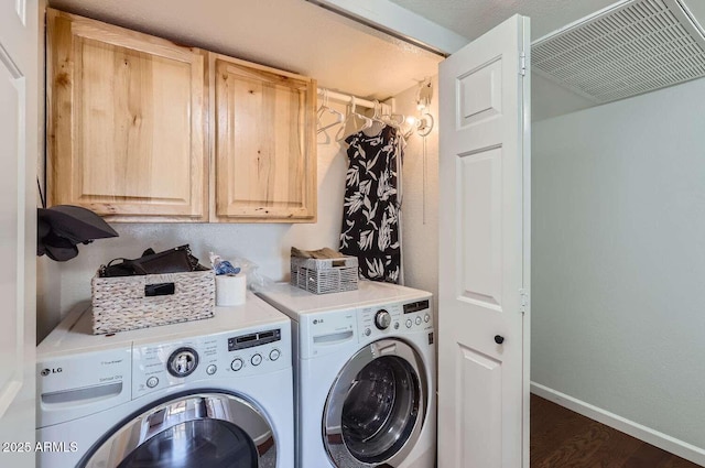 laundry area with cabinet space, visible vents, baseboards, washer and clothes dryer, and wood finished floors