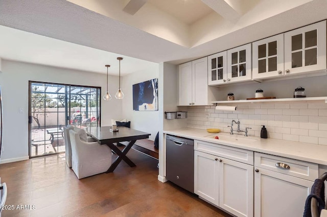 kitchen featuring stainless steel dishwasher, a sink, white cabinetry, and decorative backsplash