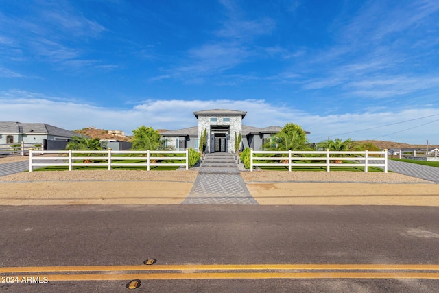 view of front of property featuring a fenced front yard and a gate