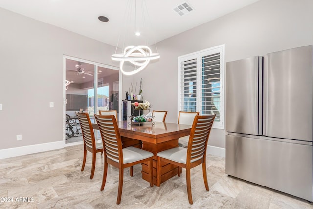 dining room with visible vents, baseboards, and a notable chandelier