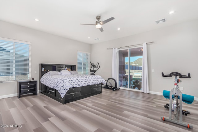 bedroom featuring light hardwood / wood-style flooring, ceiling fan, and access to exterior