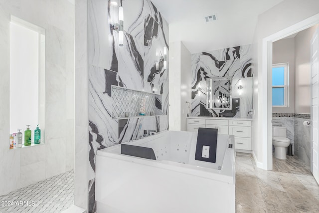 bathroom featuring vanity, tile walls, toilet, and tile patterned flooring