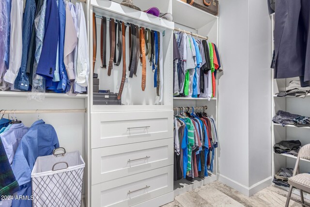 spacious closet with light hardwood / wood-style floors