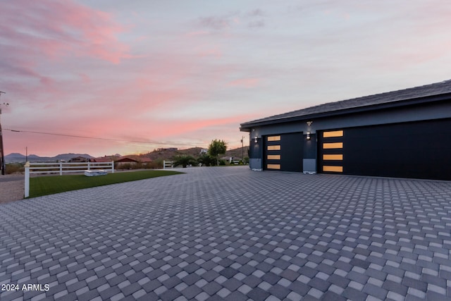 view of garage at dusk