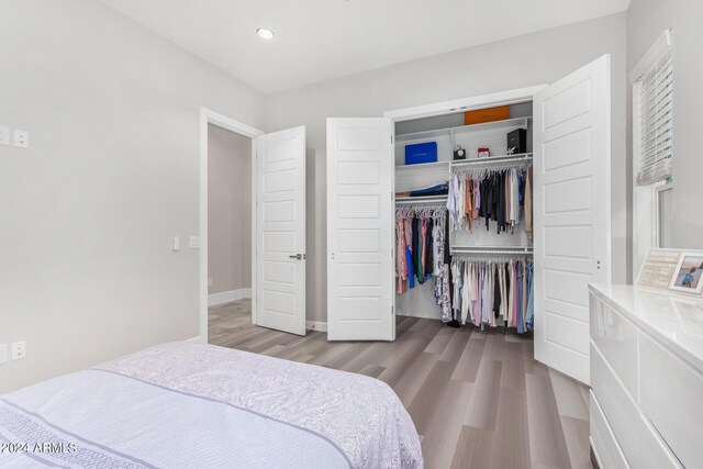 bedroom featuring light hardwood / wood-style flooring and a closet