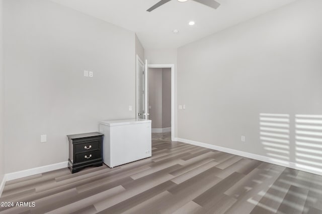 spare room with recessed lighting, a ceiling fan, baseboards, and wood finished floors