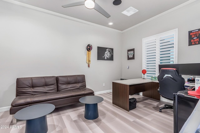 office featuring visible vents, a ceiling fan, crown molding, light wood finished floors, and baseboards