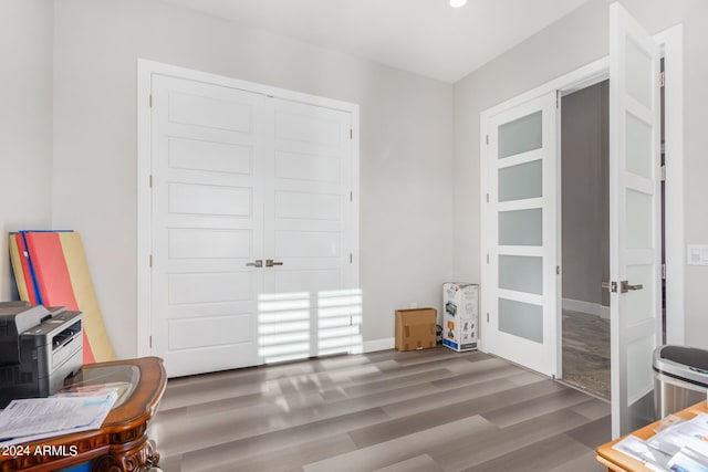 interior space featuring wood finished floors, baseboards, and a closet