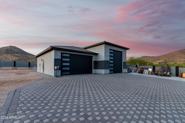 garage featuring fence and a mountain view