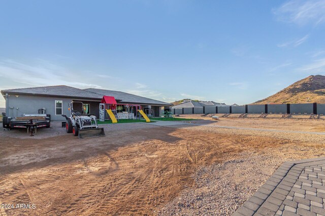 view of yard with a mountain view and a playground