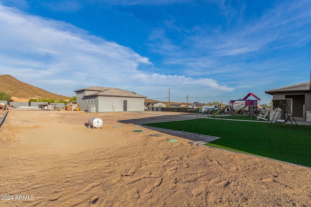 view of yard with a mountain view and playground community