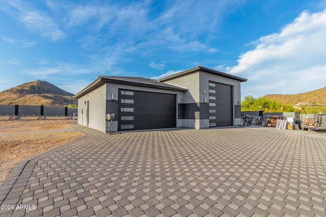 garage with a mountain view and fence