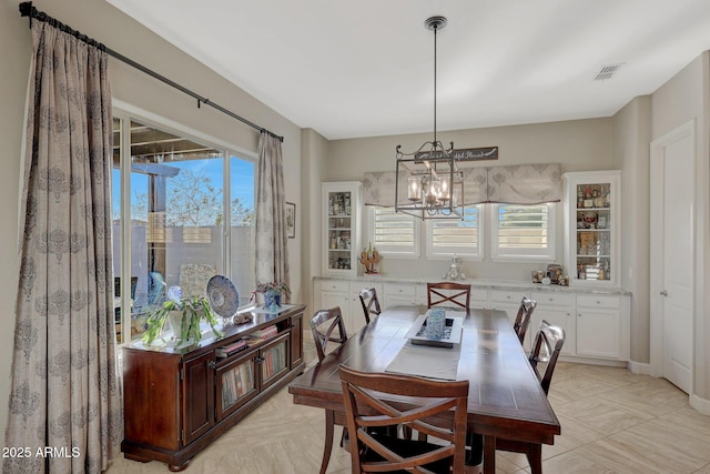 dining space with an inviting chandelier