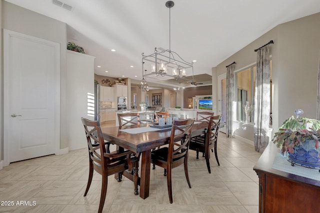 dining area with plenty of natural light and a notable chandelier