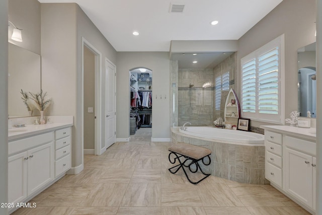 bathroom with vanity and plus walk in shower